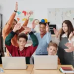 A coding teacher leading an energetic class